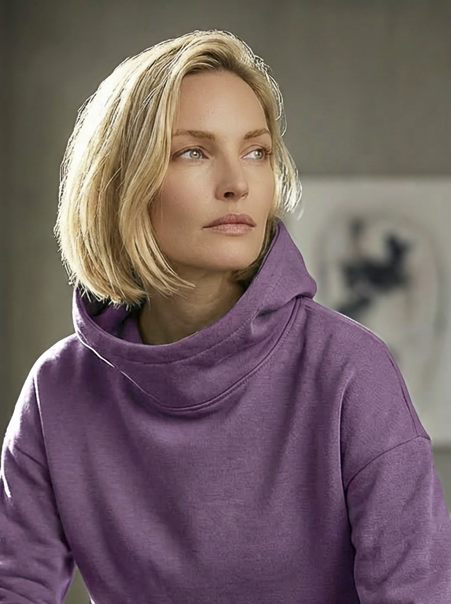 Model wearing Bou Clothing’s Sorbet Deryn luxury hoodie in a softly lit modern interior, showcasing a relaxed fit, premium fabric, and minimalist neutral style.