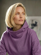 Model wearing Bou Clothing’s Sorbet Deryn luxury hoodie in a softly lit modern interior, showcasing a relaxed fit, premium fabric, and minimalist neutral style.