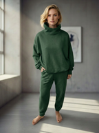 Model wearing Bou Clothing’s Forest luxury Deryn hoodie and matching joggers,  in a softly lit modern interior, showcasing a relaxed fit, premium fabric, and minimalist neutral style.