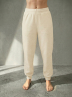Front view of Deryn Jogger by Boue Clothing in Cream against a stone grey backdrop.